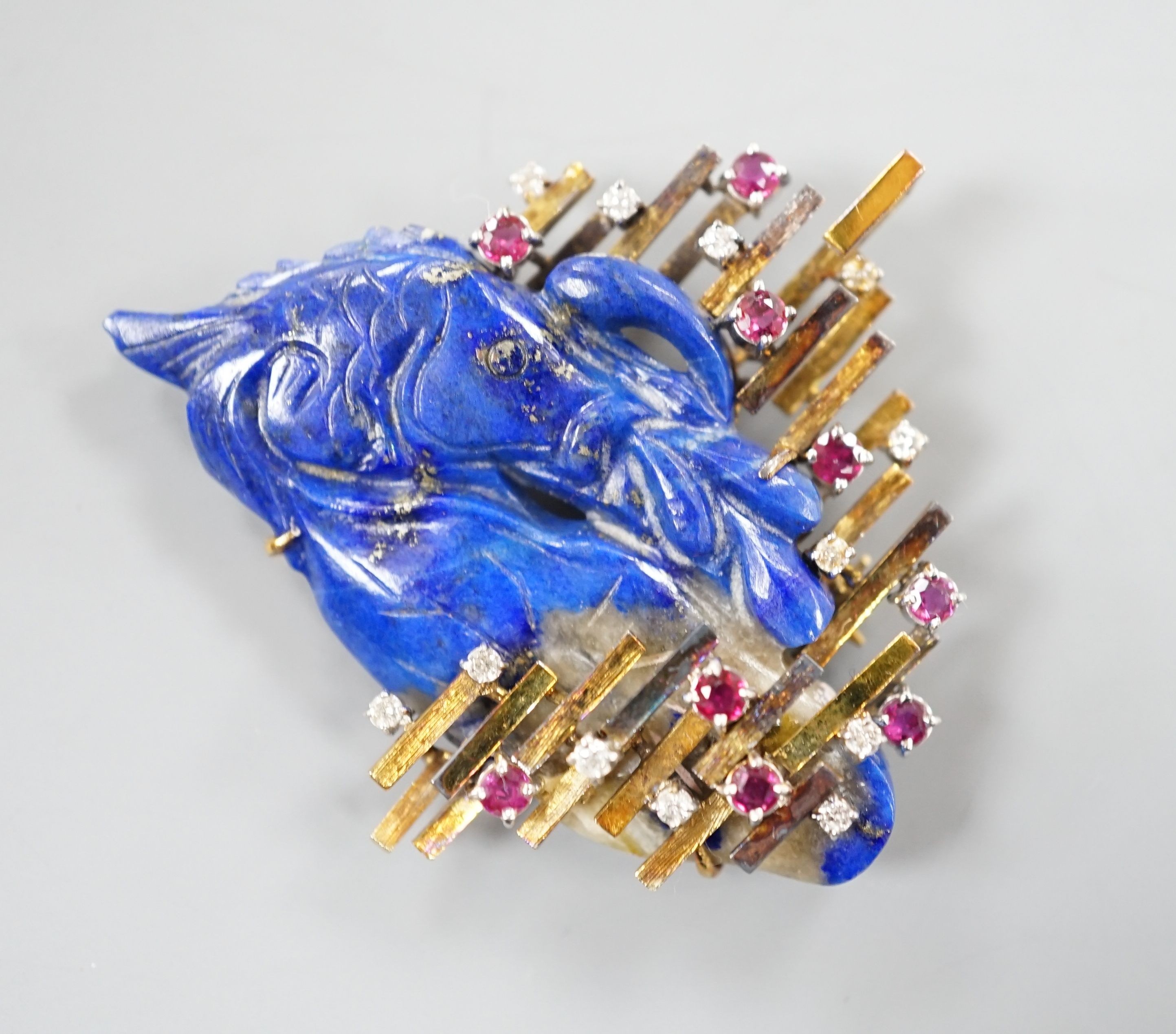 A 585 yellow metal, ruby, diamond and apis lazuli set modernist brooch, maker's mark KK, width 52mm, gross weight 21.4 grams